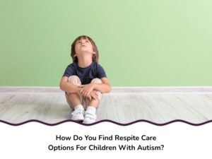 A young boy sits on a wooden floor looking up, symbolising need for respite care for children with autism.