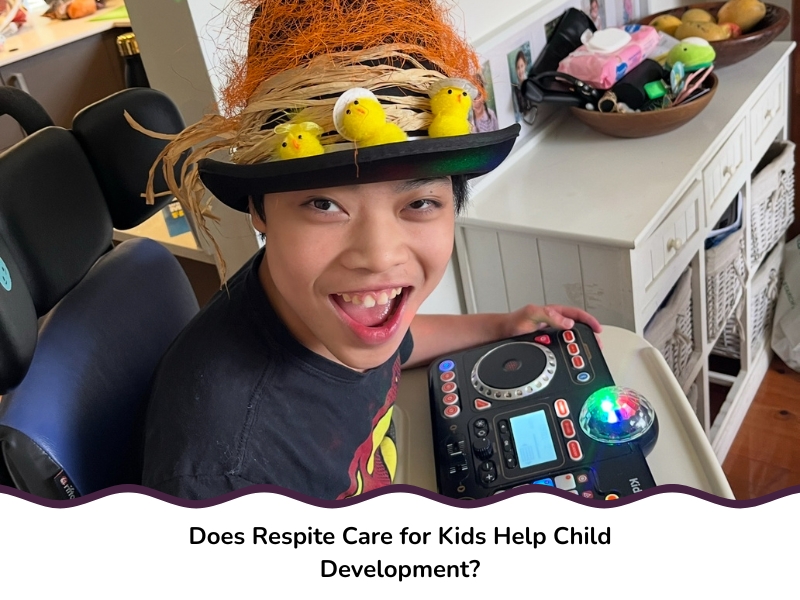 Boy wearing a festive hat using an interactive toy indoors, smiling brightly during respite care for kids.