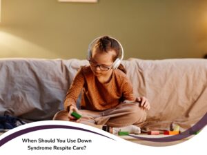Young girl with Down syndrome wearing headphones and playing blocks on couch, symbolising calm during down syndrome respite care.