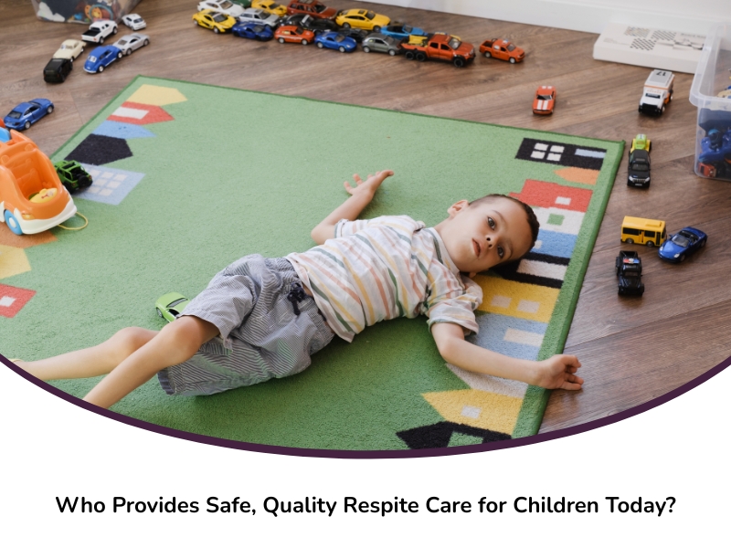 A young boy lies on a colourful mat surrounded by toy cars, representing playful downtime during respite children care.