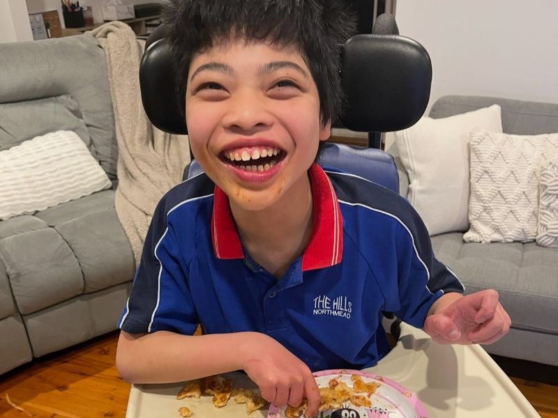 Teenager enjoying a quiet activity during personalised respite care in Sydney, NSW, without joining group activities.